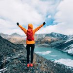 Woman hiker in high mountains winter